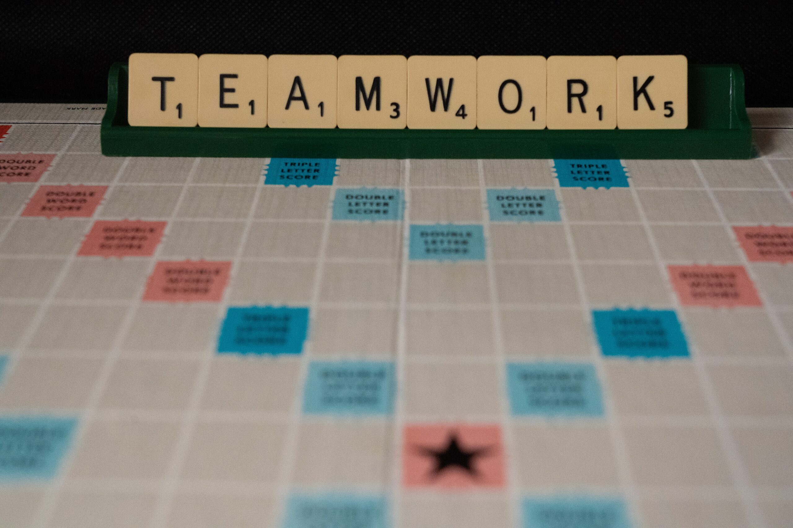 scrabble board spelling teamwork